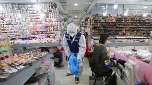 A worker wearing protective gears sprays disinfectant inside a store as a precaution against a new coronavirus at Namdaemun Market in Seoul, South Korea, Wednesday, Feb. 5, 2020. Deaths from a new virus rose to 490 in mainland China on Wednesday while new cases on a Japanese cruise ship, in Hong Kong and in other places showed the increasing spread of the outbreak and renewed attention toward containing it. (AP Photo/Ahn Young-joon)